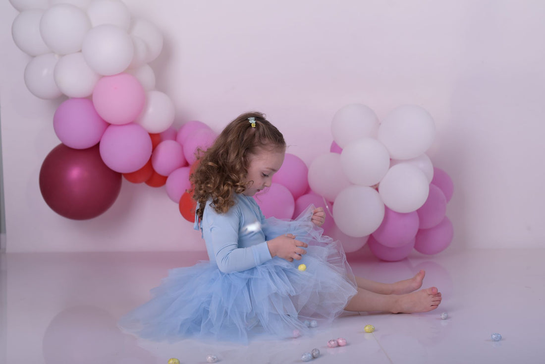a little girl sitting on the floor in front of balloons Baby Girl Dress for Special Occasion