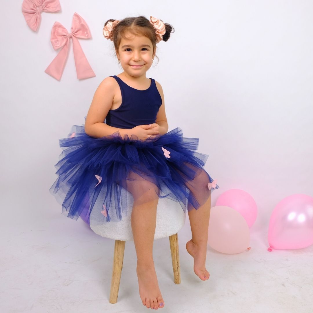a little girl sitting on a chair in a blue dress Baby Girl Dress for Special Occasion