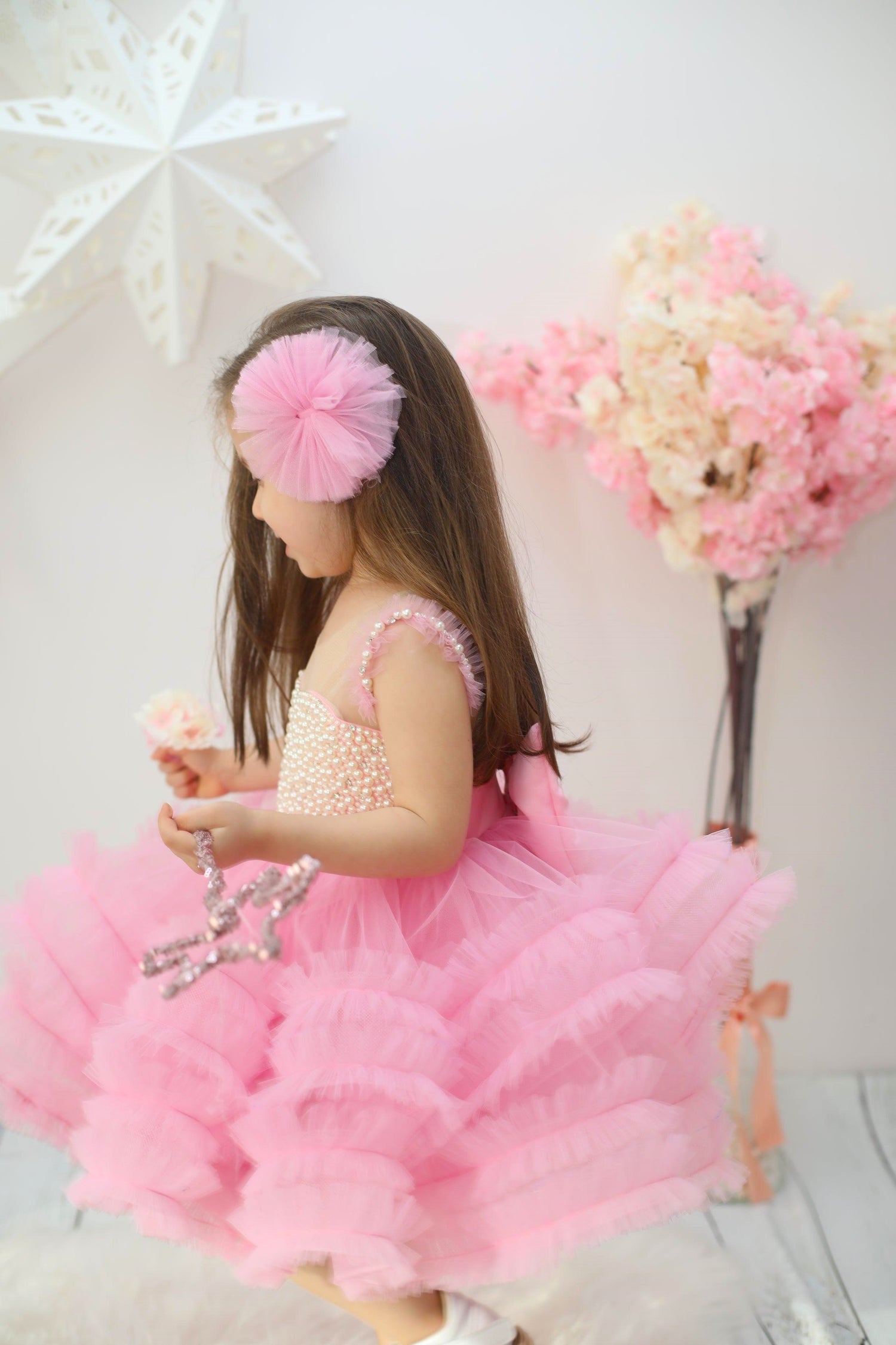 Elegant pink dress with ruffle details, crafted from cotton, tulle, satin, and embellished with pearls, ideal for formal events. Baby Girl Dress