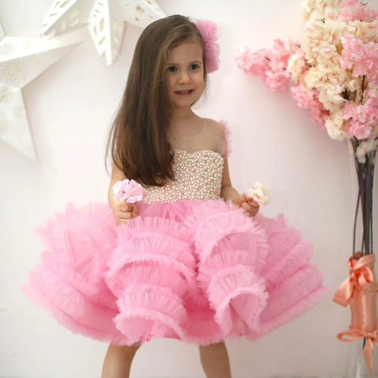 Delicate pink ruffle dress made of cotton, tulle, satin, and adorned with pearls, perfect for special occasions. Baby Girl Dress
