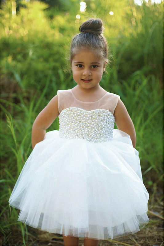 Elegant white dress with pearl and rhinestone accents, crafted from cotton, tulle, and satin.