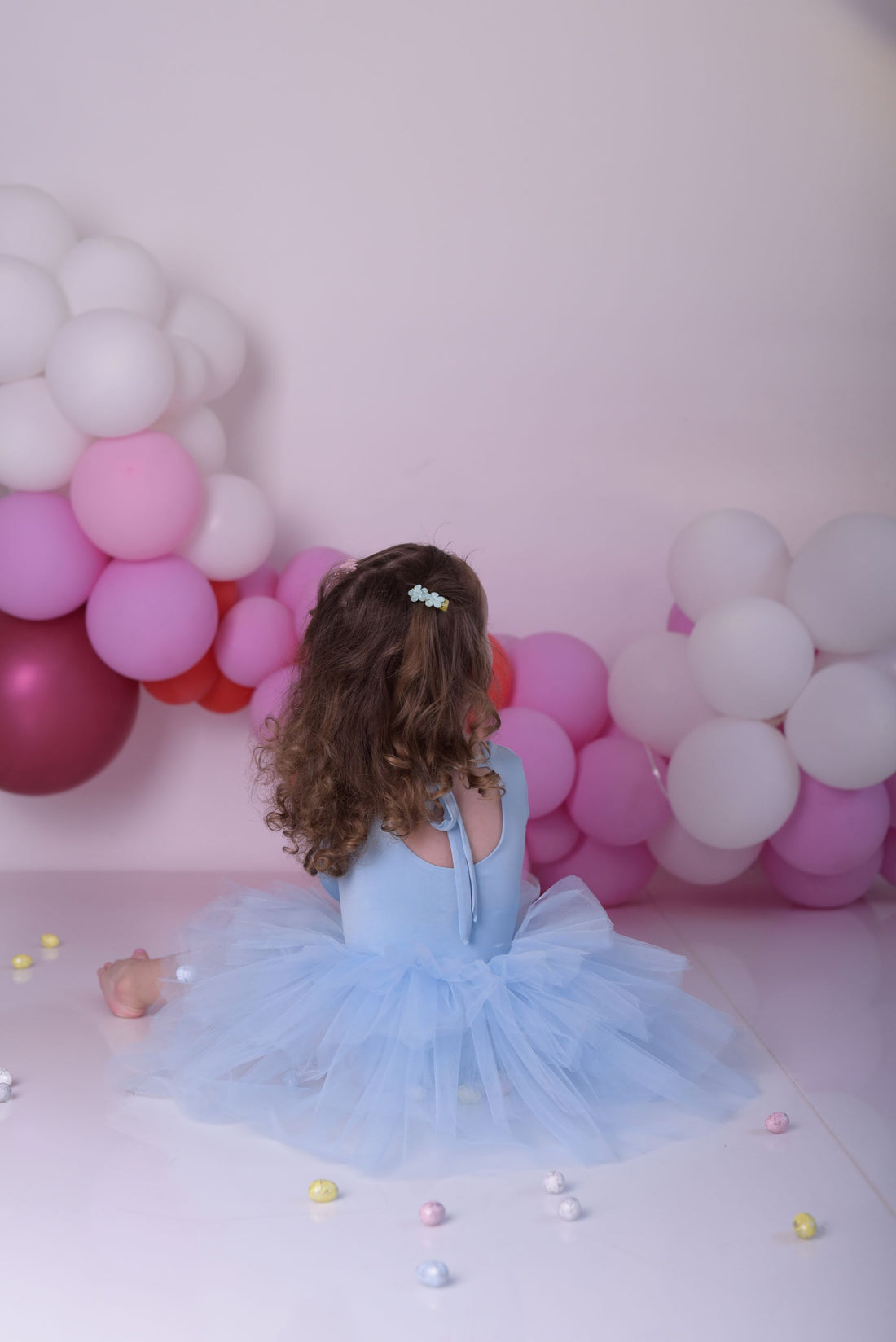 a little girl sitting on the floor in front of balloons Baby Girl Dress for Special Occasion