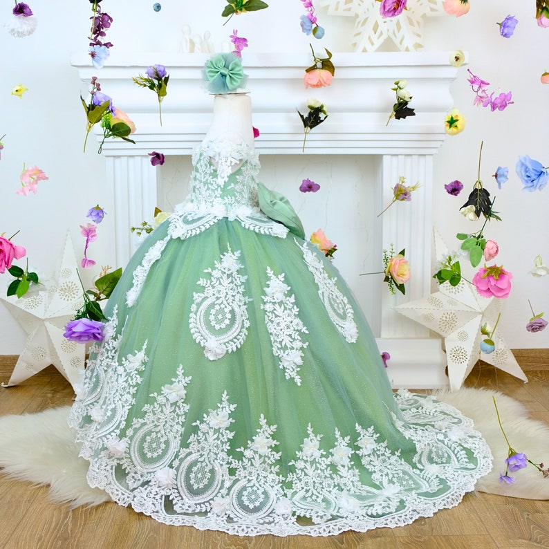 The corset part of the sage green dress is laced and has laser flowers on it. The whole skirt is embroidered with lace and tulle on tulle. Baby Girl Dress for Special Occasion