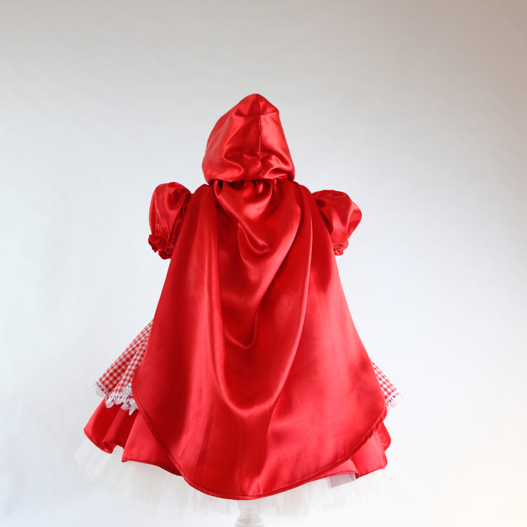a red cape on a mannequin on a white background