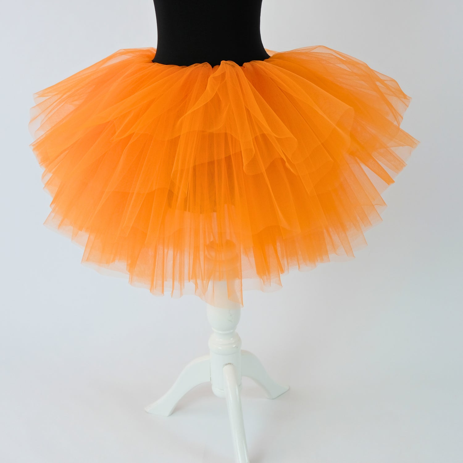 a mannequin wearing a black top and orange tutu Baby Girl Dress