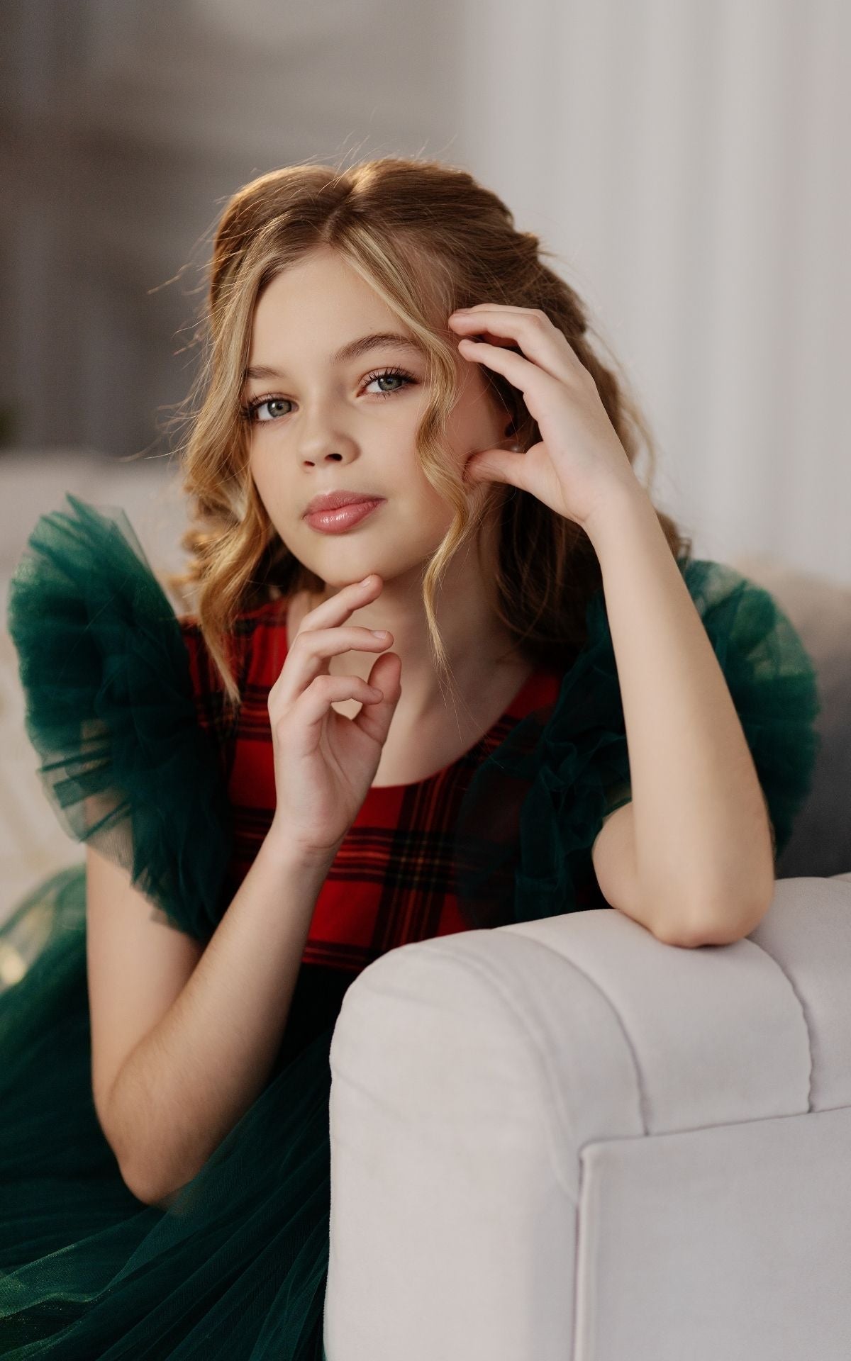 a woman sitting on top of a white couch Baby Girl Dress
