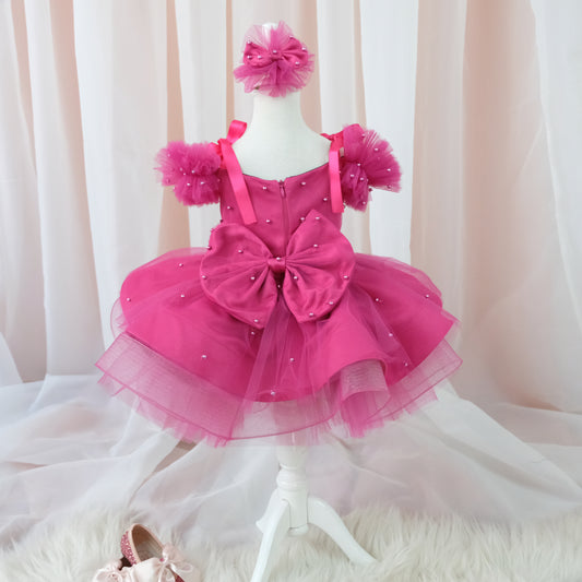 a pink dress and shoes on a mannequin