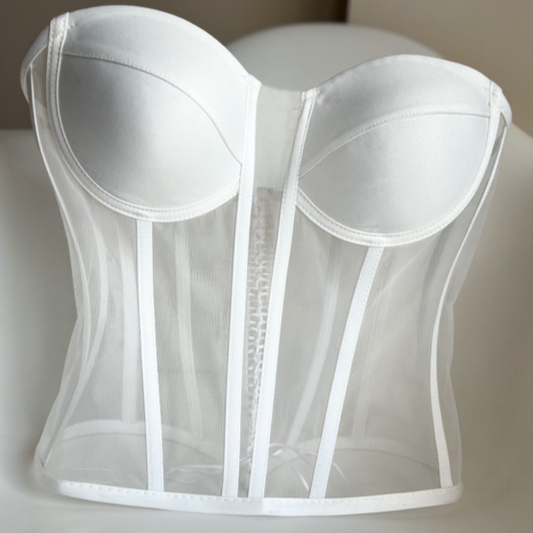 a white corset on a white surface