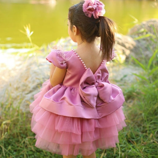 a little girl in a pink dress looking at the water Baby Girl Dress