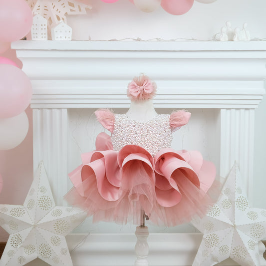 a baby girl's pink and white dress and star decorations