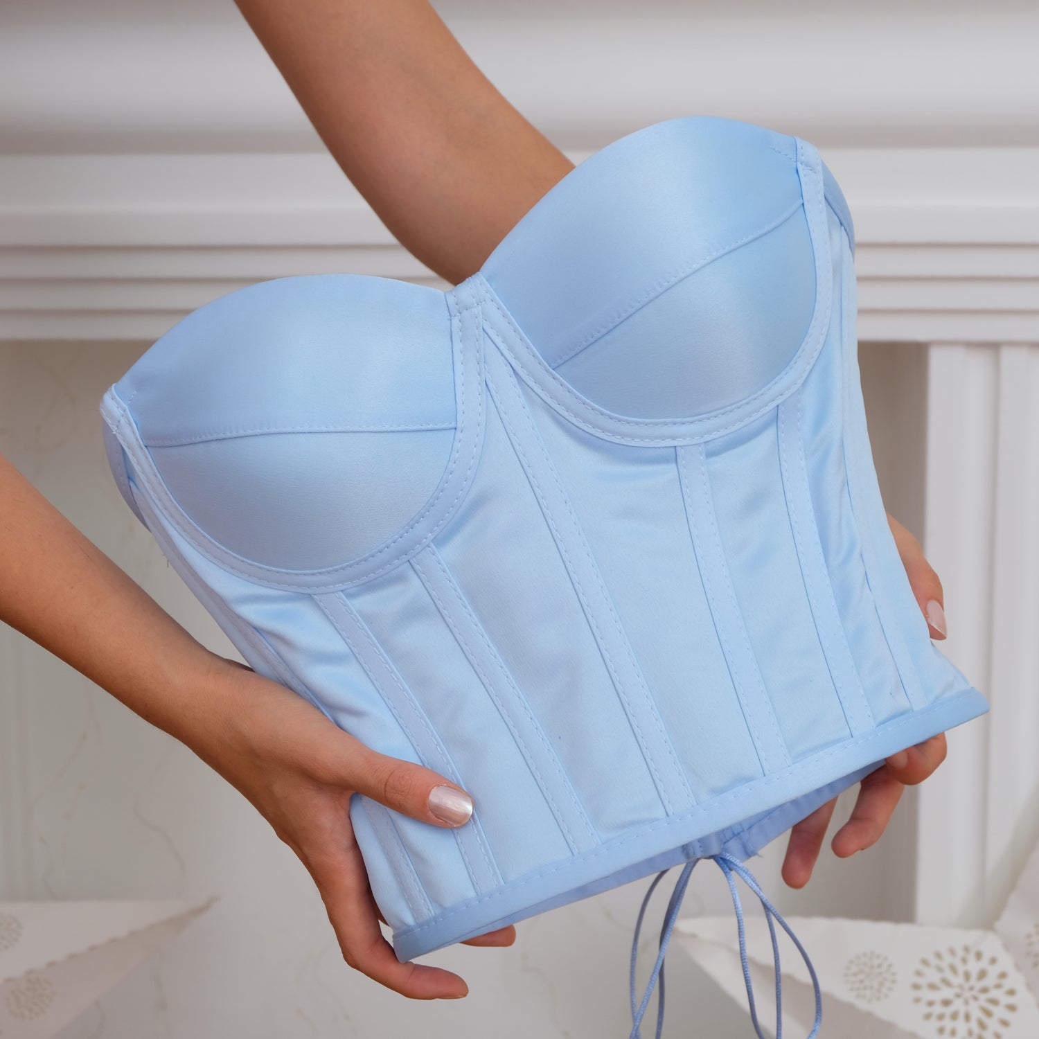 a woman holding a blue bra in her hands Baby Girl Dress