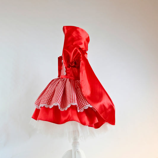 a red and white dress on a white stand