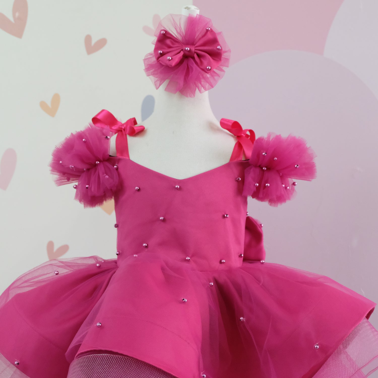 a pink dress on a mannequin on a dummy Baby Girl Dress