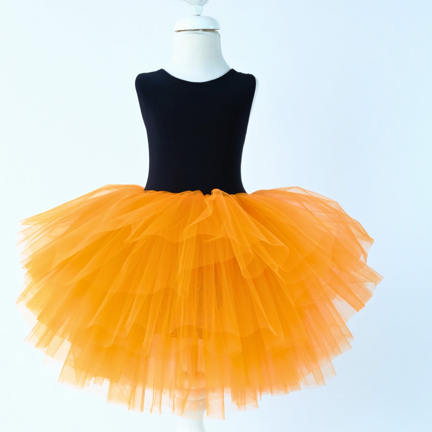 a mannequin wearing a black top and orange tutu Baby Girl Dress