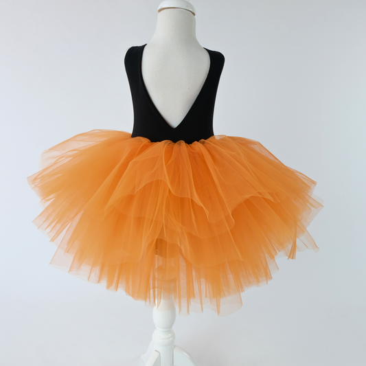 a mannequin wearing a black and orange dress