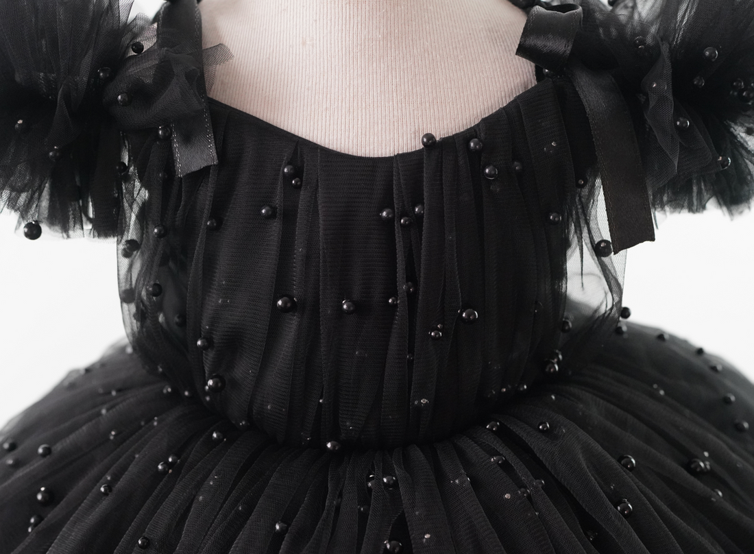 a woman wearing a black dress with pearls on it Baby Girl Dress for Special Occasion