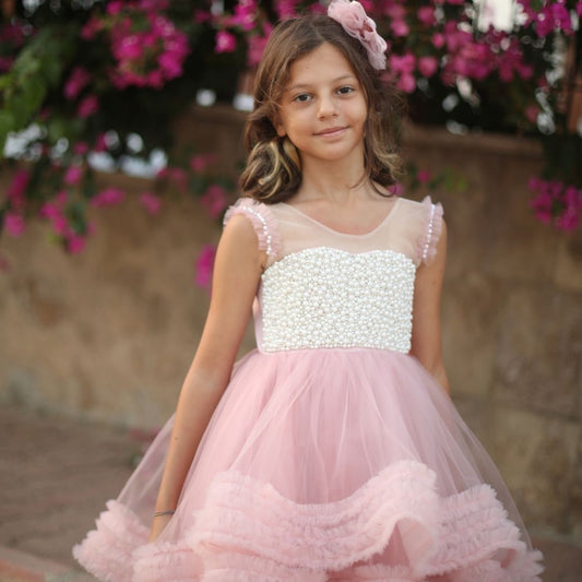 a little girl in a pink dress standing in front of flowers Baby Girl Dress