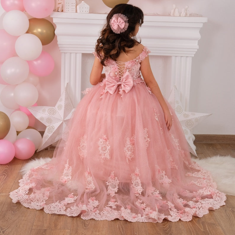 Elegant blush quinceañera dress featuring a satin bodice adorned with delicate lace and 3D floral appliqués, a voluminous tulle skirt with sparkling accents, and a coordinating hair accessory for a stunning look. Baby Girl Dress for Special Occasion