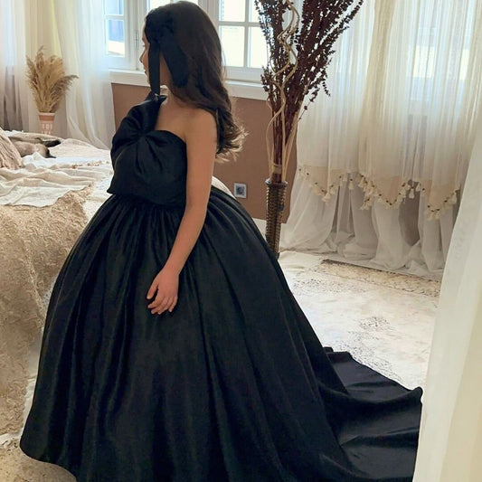 a woman in a black dress standing in front of a window Baby Girl Dress