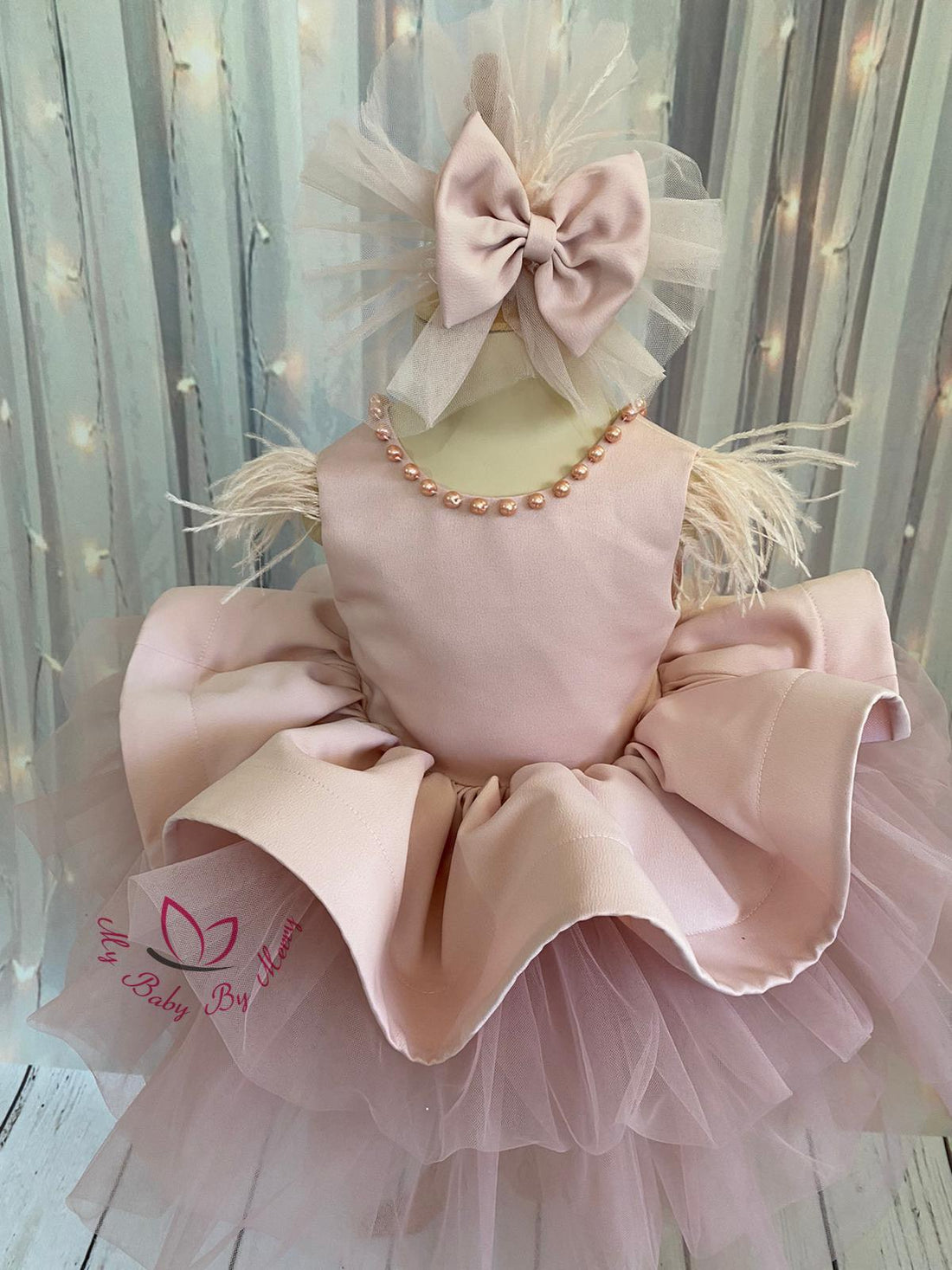 Adorable blush baby girl dress with delicate pearl detailing, featuring a soft and elegant design. Perfect for special occasions, this dress combines charm and comfort for your little one. Baby Girl Dress for Special Occasion