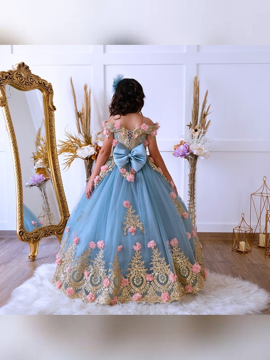The bodice of the light pastel blue dress is laced and has laser flowers on it. The whole skirt is embroidered with lace and tulle on tulle.