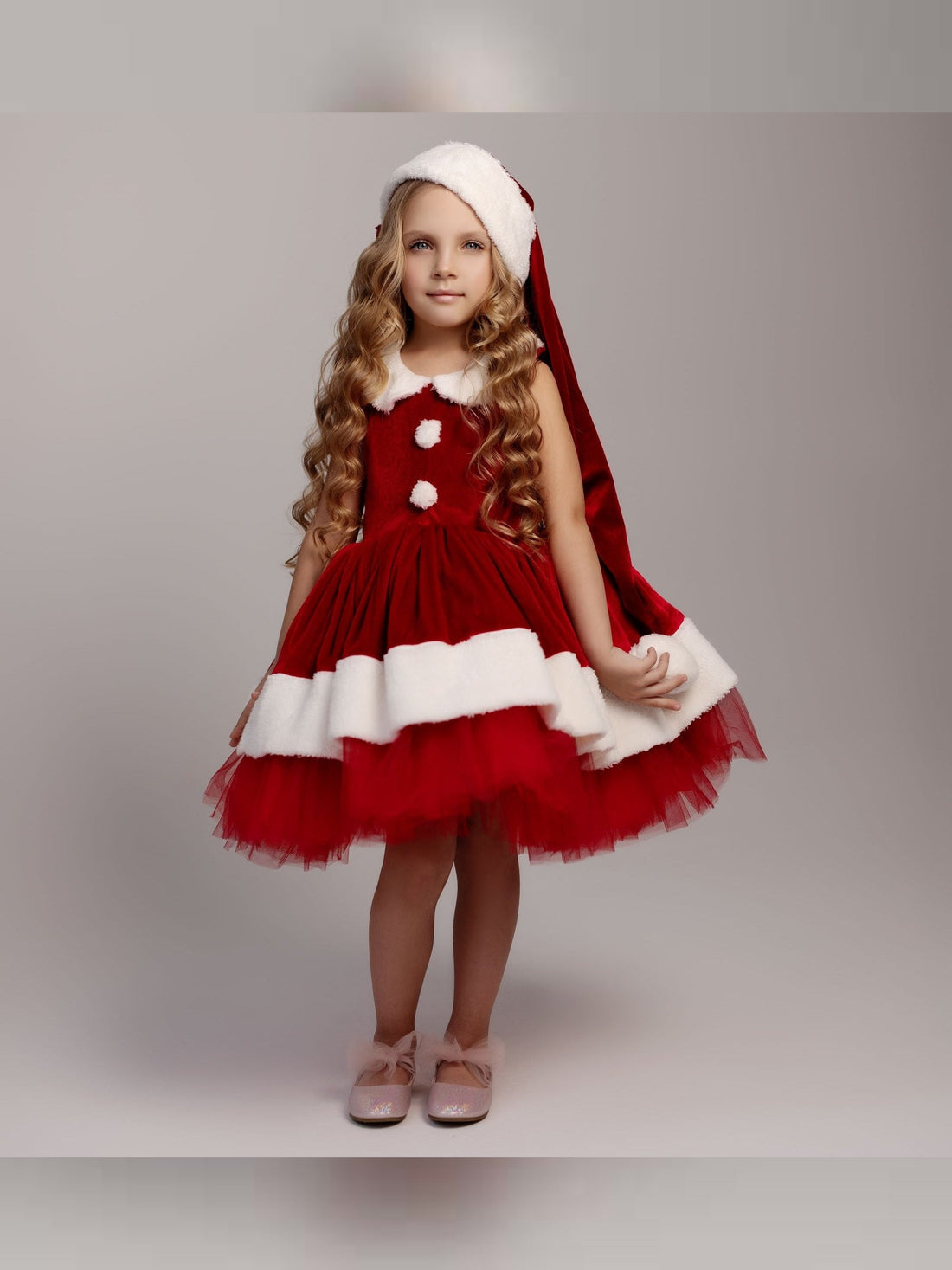 a little girl dressed up as santa clause