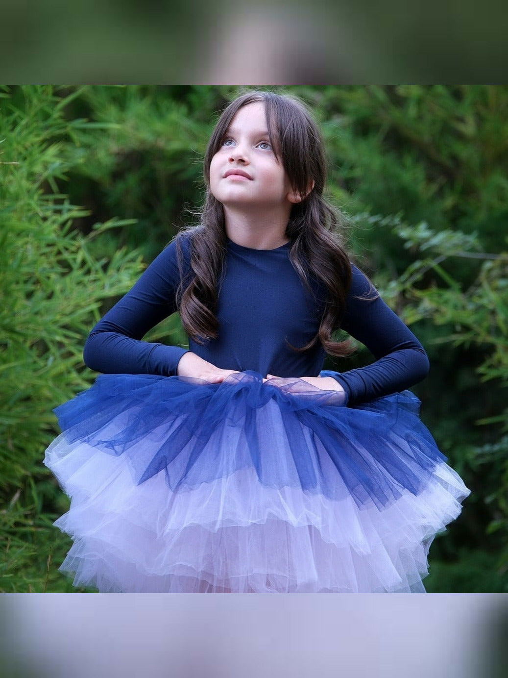 a little girl wearing a blue and white dress