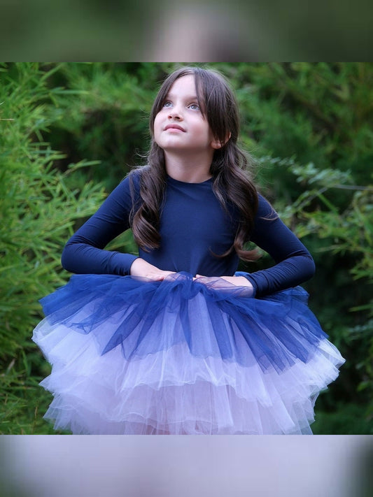 a little girl wearing a blue and white dress