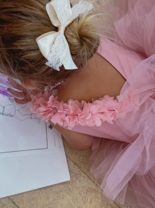 Blush ballerina tutu with floral accents, perfect for dance and special occasions.