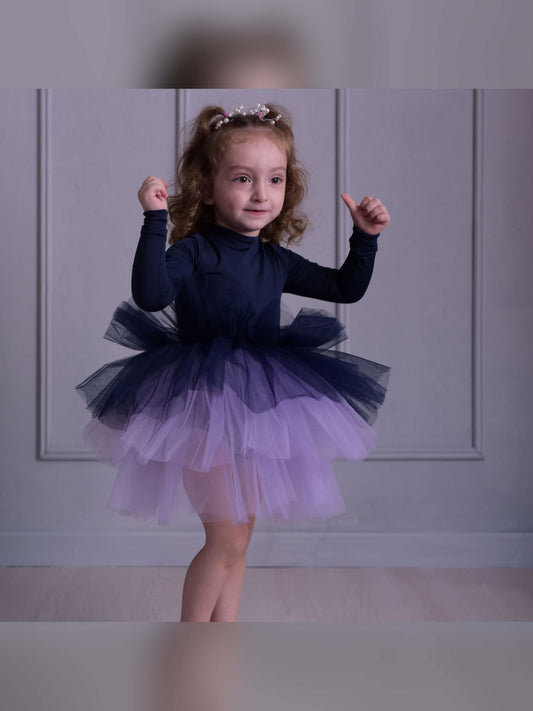 a little girl wearing a purple and blue dress