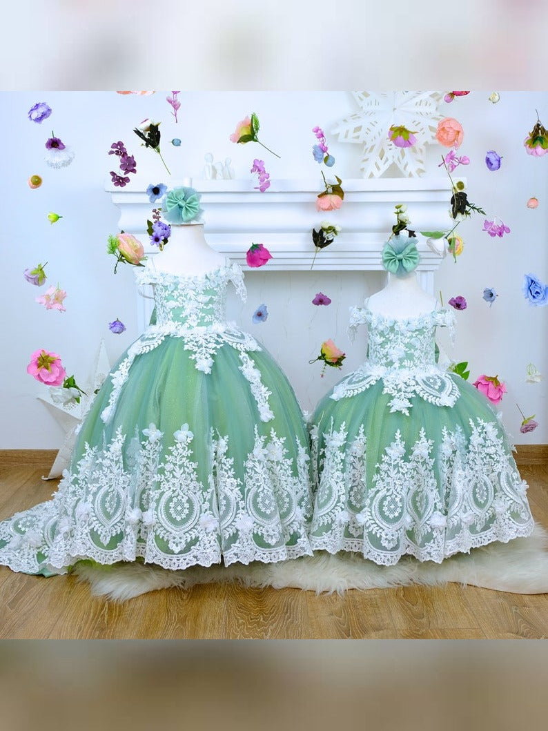 The corset part of the sage green dress is laced and has laser flowers on it. The whole skirt is embroidered with lace and tulle on tulle.