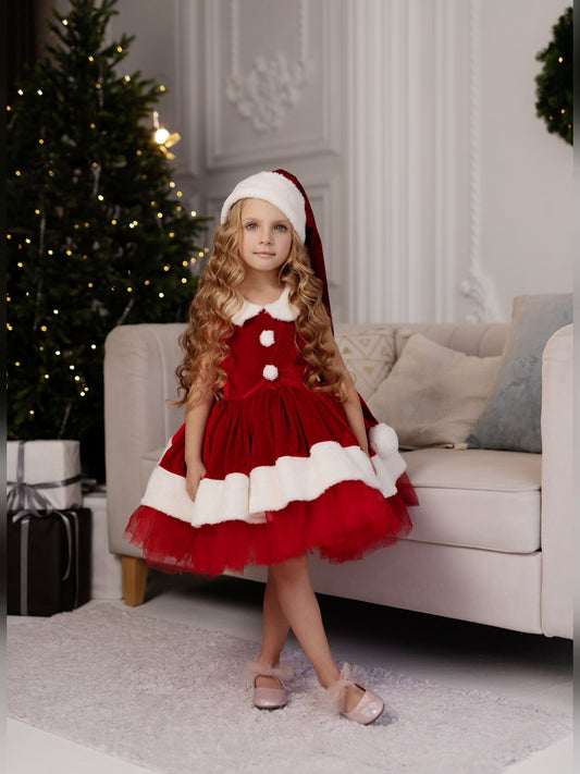 a little girl dressed in a red and white dress