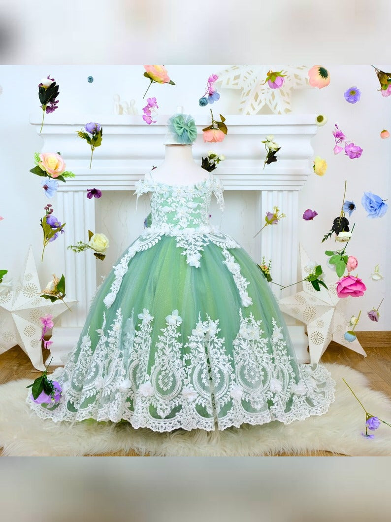The corset part of the sage green dress is laced and has laser flowers on it. The whole skirt is embroidered with lace and tulle on tulle.