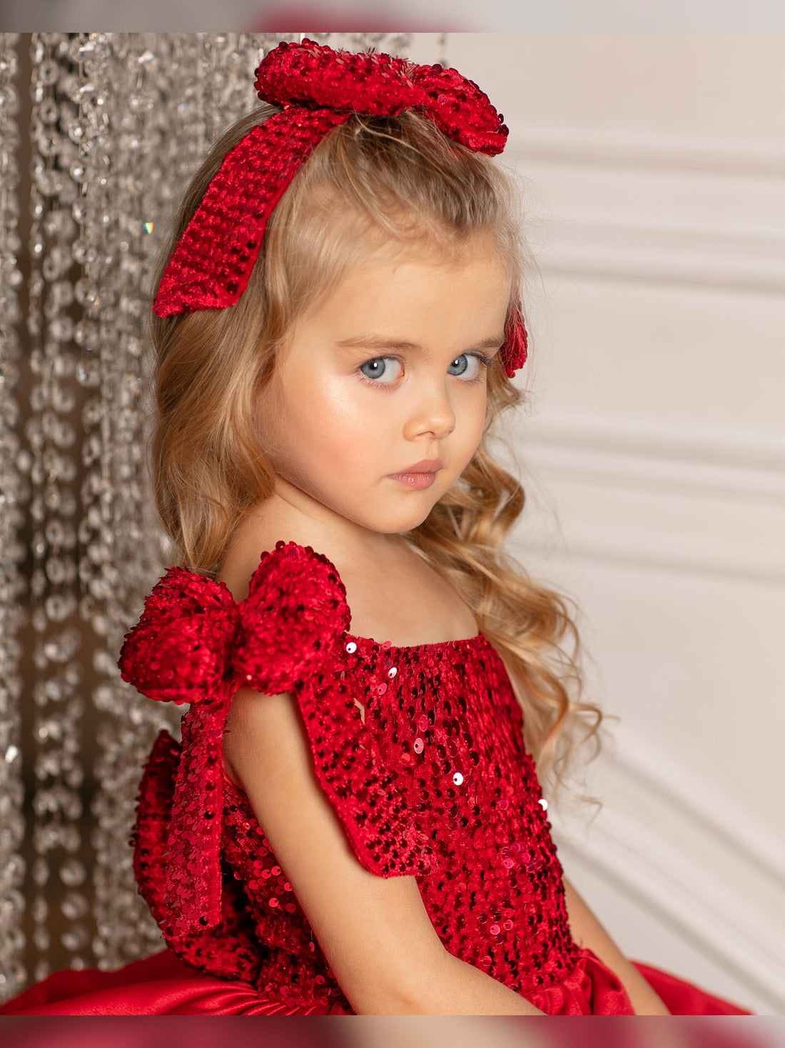 Christmas toddler dress with velvet red satin and a shimmering sparkly bow, perfect for special occasions
