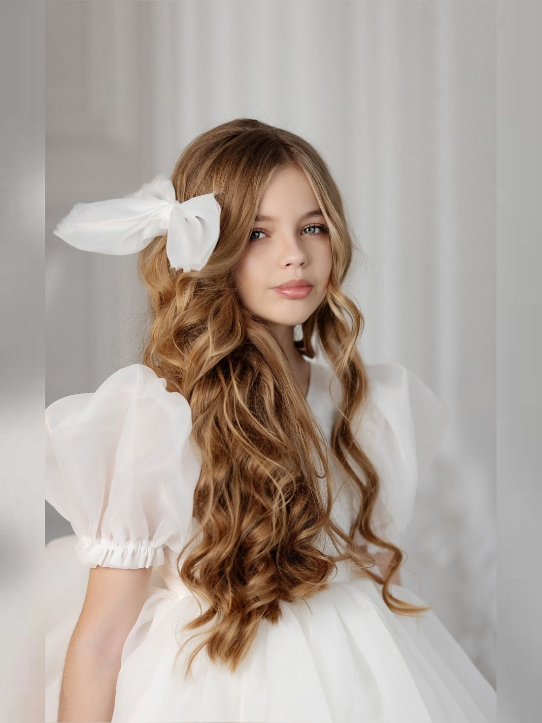 a woman with long hair wearing a white dress