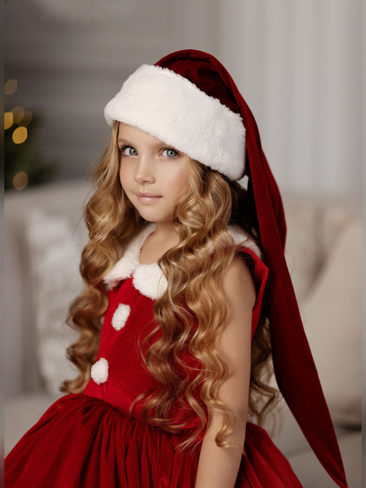 a little girl wearing a santa claus hat