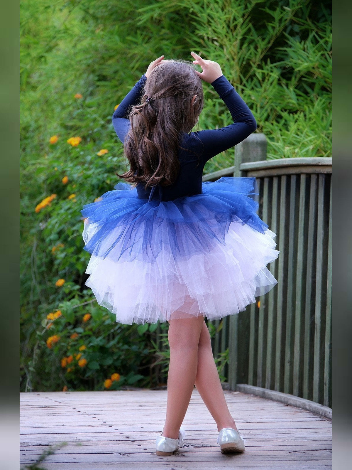 a little girl in a blue and white dress