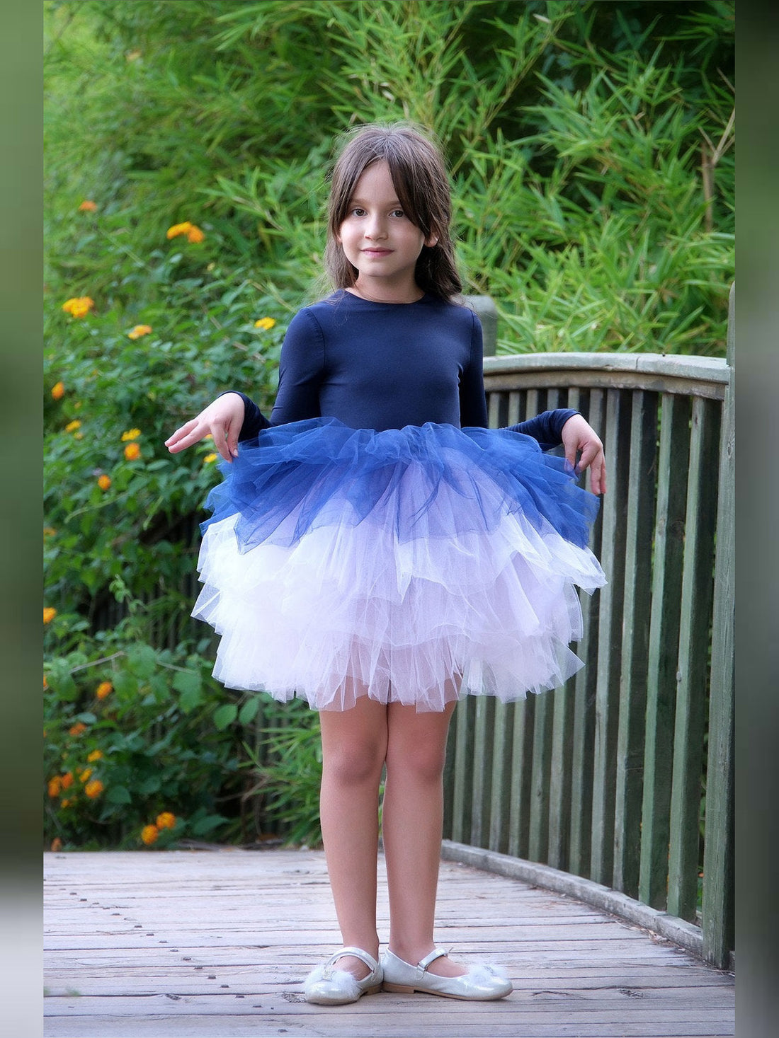 a little girl wearing a blue and white dress