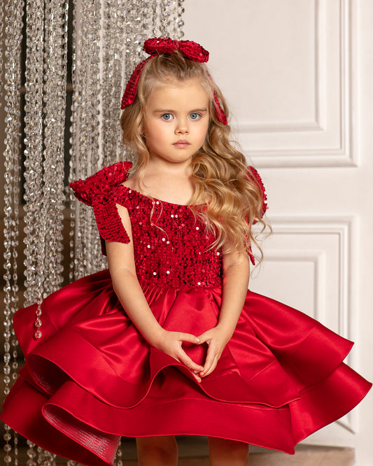 Elegant red velvet Christmas dress for toddler girls, featuring a satin fabric and a sparkling bow.