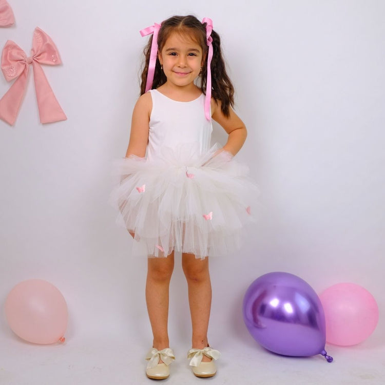 a little girl standing next to balloons and balloons