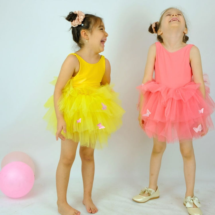 two little girls standing next to each other