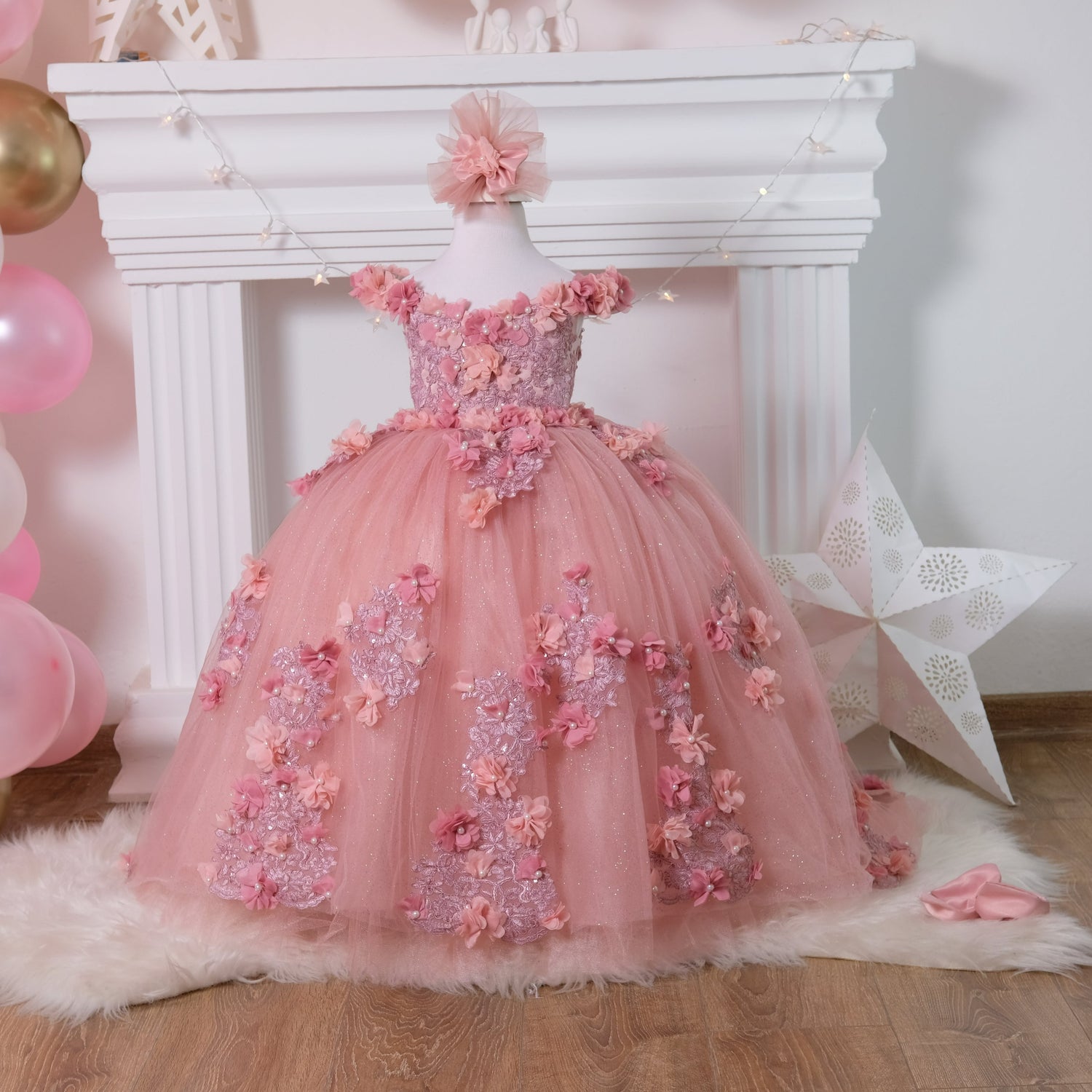 Delight in elegance with our satin and lace dress, featuring a bodice adorned with 3D colorful flowers and intricate details. The skirt boasts multiple layers of glittery tulle and lace, complemented by a soft cotton lining for comfort. Includes a matching gift hair accessory for the perfect finishing touch. Baby Girl Dress