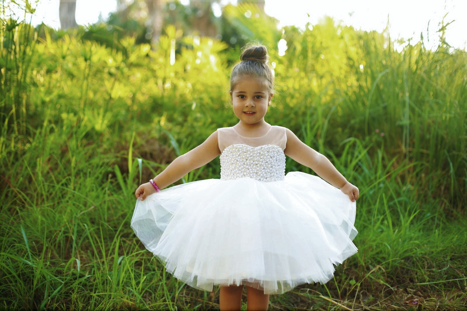 White dress featuring pearls and rhinestones, made from soft cotton, layered tulle, and satin fabric.