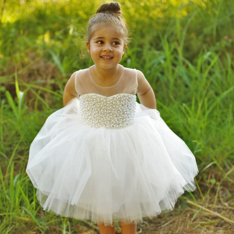 White pearl dress made of cotton, tulle, and satin with rhinestone and pearl details, perfect for special occasions.