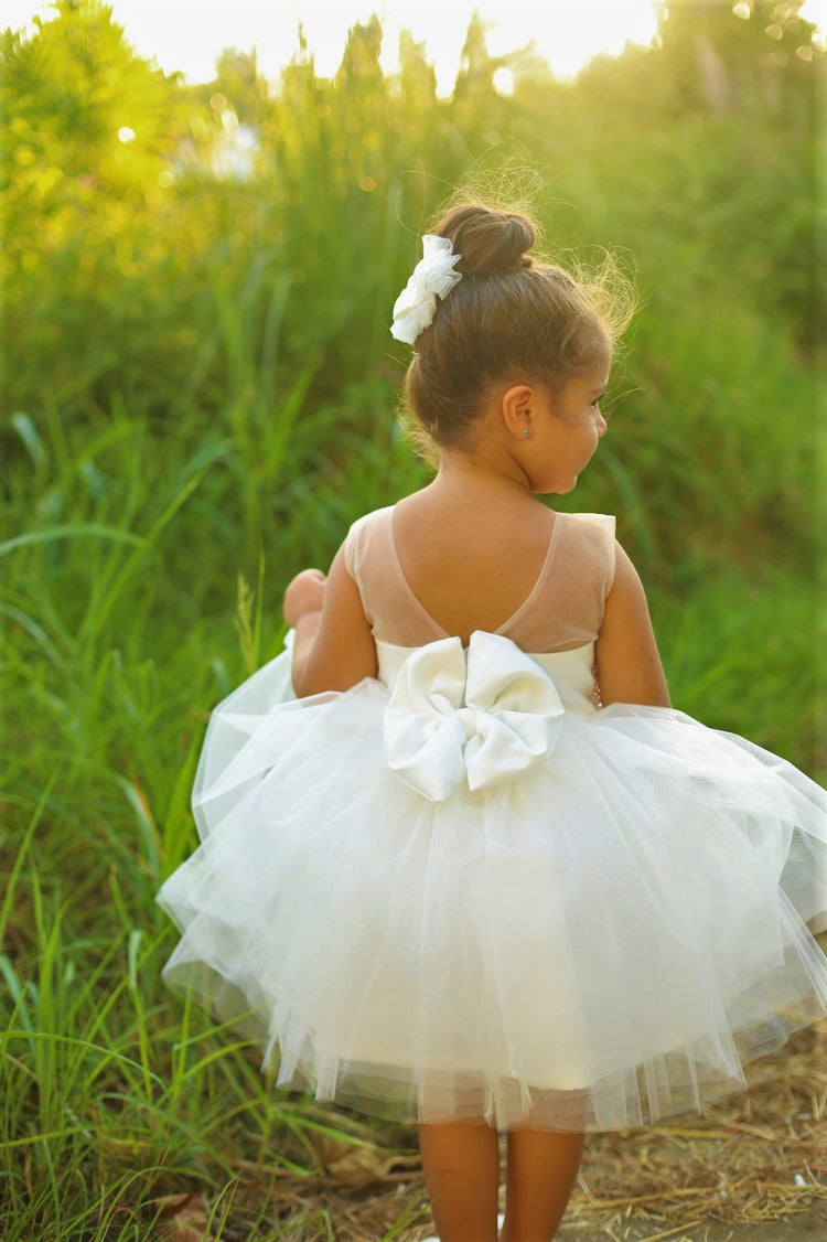 White dress featuring pearls and rhinestones, made from soft cotton, layered tulle, and satin fabric.