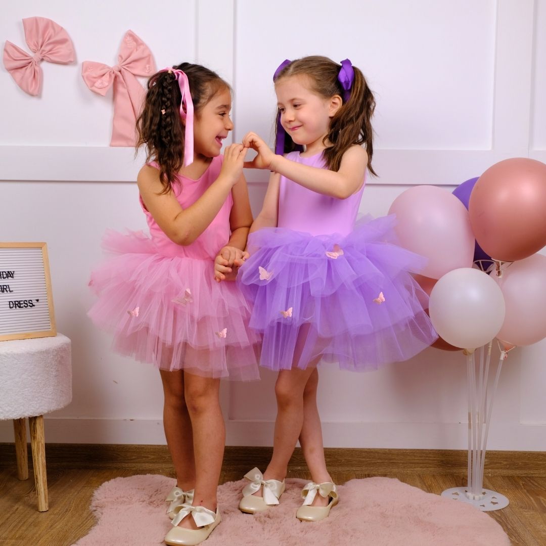 two little girls standing next to each other