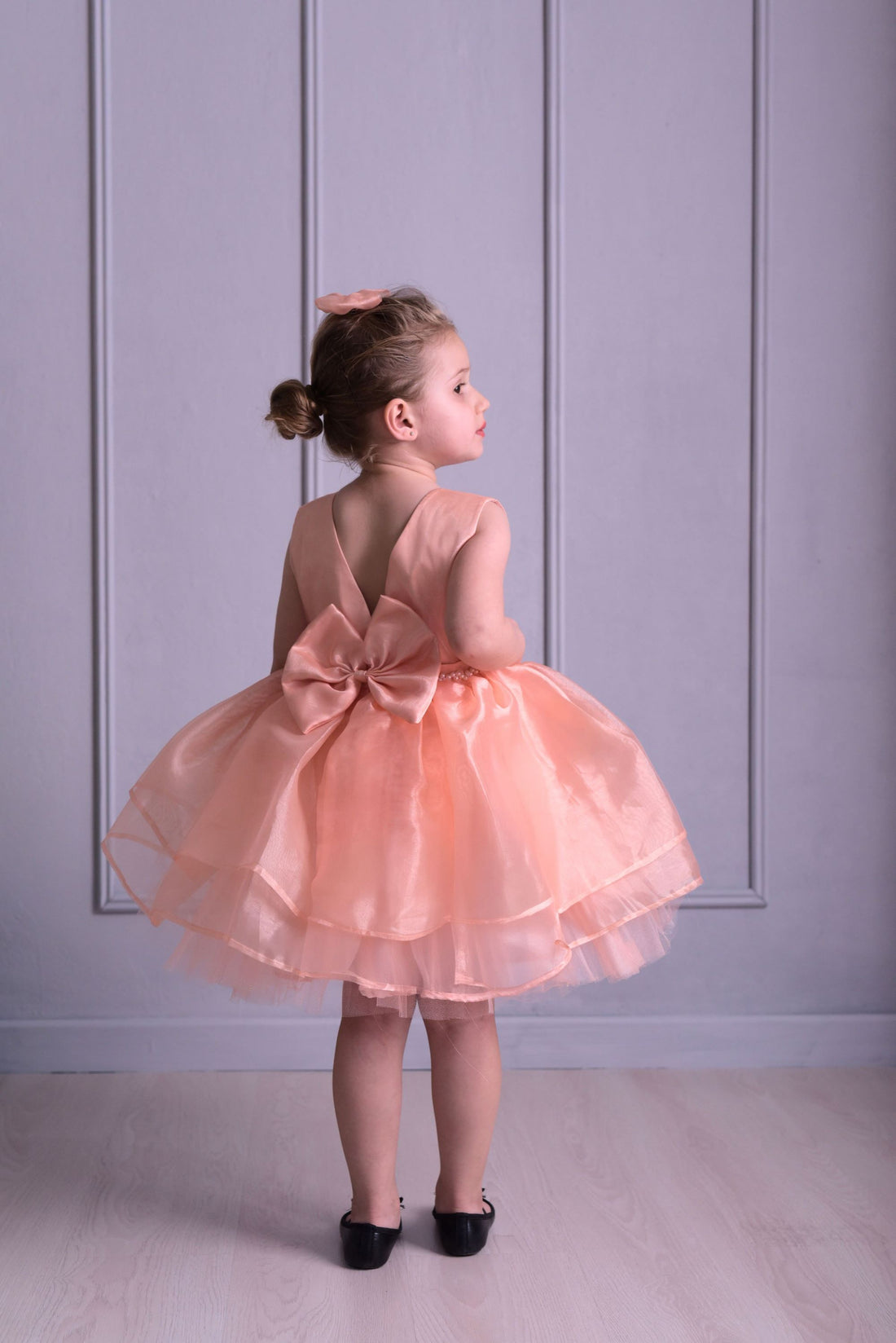 a little girl in a pink dress standing on a wooden floor Baby Girl Dress for Special Occasion