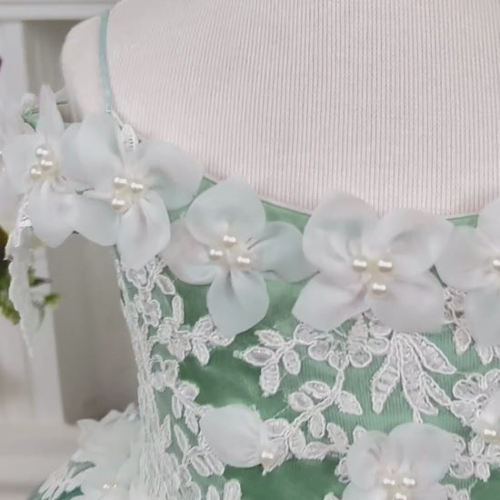 Beautiful sage green Quinceañera dress featuring a graceful design and elegant detailing. The soft sage green color adds a touch of sophistication, making it perfect for a stylish and memorable Quinceañera celebration.