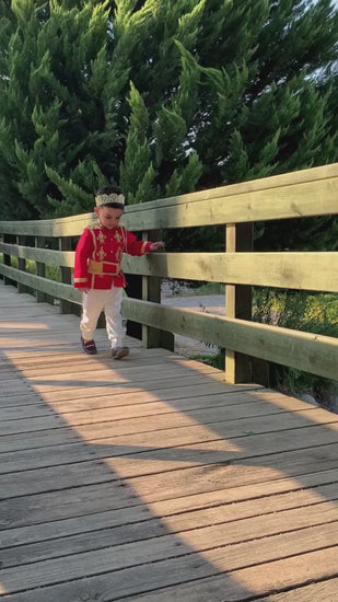 Prince Charming red costume for boys, featuring a striking red jacket with gold accents and matching pants. Perfect for costume parties or themed events, this outfit embodies the classic fairytale prince look
