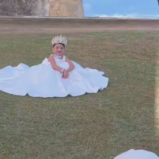 Back view of white communion ball gown with oversized bow